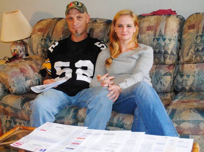 Phillip Swaney and his fiance Heather Wollschlagler show their $60,000 in medical bills.