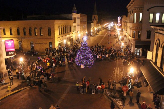 Electric Light Christmas Parade and Hometown Holiday attendees gather around the Main Street Christmas Tree in downtown Ionia during last year's event before the parade begins. This year's event will take place Friday, which will begin with a countdown to 6 p.m. when the tree will be lit and carols will be sung. The parade will begin at 6:30 p.m.
