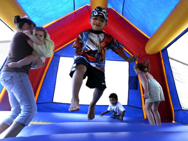 FILE - In this Sept. 11, 2005 file photo, children play in a bounce house in Vidor, Texas. A nationwide study released Monday, Nov. 26, 2012, found inflatable bounce houses can be dangerous and the number of kids injured in related accidents has soared 15-fold in recent years. The numbers suggest 30 U.S. children a day are treated in emergency rooms for broken bones, sprains, cuts and concussions from bounce house accidents. (AP Photo/LM Otero, File)