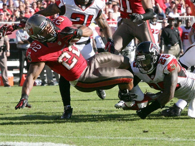 Tampa Bay Buccaneers running back Doug Martin (22) is stopped short of the goal line in the third quarter by Atlanta Falcons safety William Moore (25) during their game at Raymond James Stadium in Tampa. Sunday Nov. 25, 2012