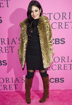 At the taping of the Victoria’s Secret Fashion Show this month,Vanessa Hudgens hit the pink carpet in a knit dress and leopard print coat, braving the chill with stockings, leg warmers and knee high boots.