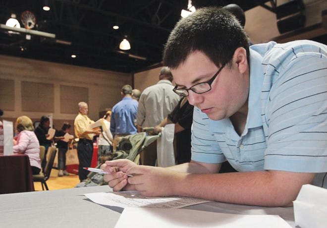 Matthew Parker fills out a job application during the Gaston Workforce Development Board's Annual Fall Job Fair at Union Road Church of God in Gastonia on Wednesday October 3, 2012.