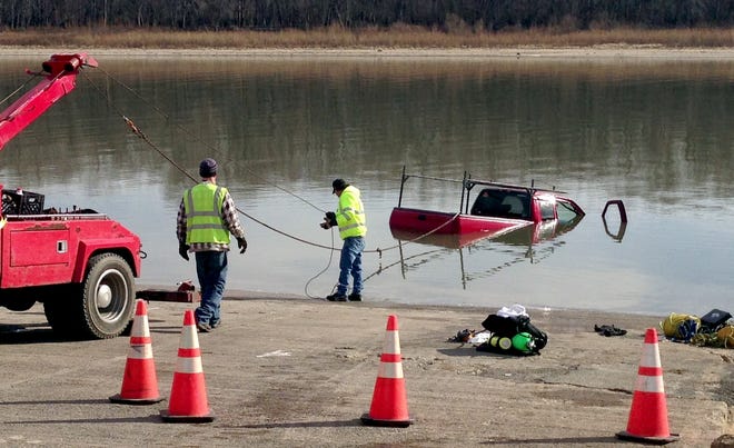 Authorities drag an abandoned pickup truck from the Illinois River at the Mendenhall Road boat ramp in Bartonville on Tuesday. The vehicle was unoccupied, and the owner said it had been parked in South Peoria until Sunday.