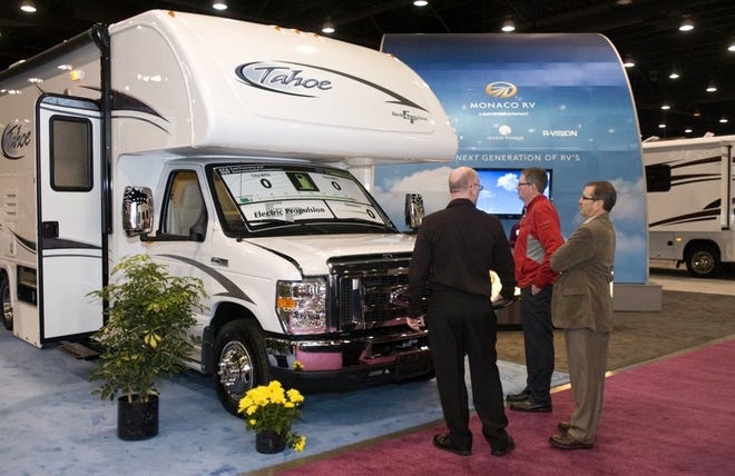 ATTENDEES LOOK at the all-electric E-Tahoe by MPV at the 49th Annual National RV Trade Show in Louisville, Ky., on Nov. 29, 2011. (BRIAN BOHANNON | THE ASSOCIATED PRESS)