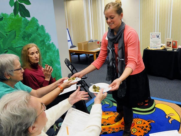 Sarah Barnwell, Family and Consumer Sciences agent with the NC Cooperative Extension, hands out samples of food she prepared for the “What Would Charles Dickens Eat?” program at the Barbee Library in Oak Island. The seminar will be held again at 1 p.m. Nov. 30 at Harper Library, 109 W. Moore St., Southport.