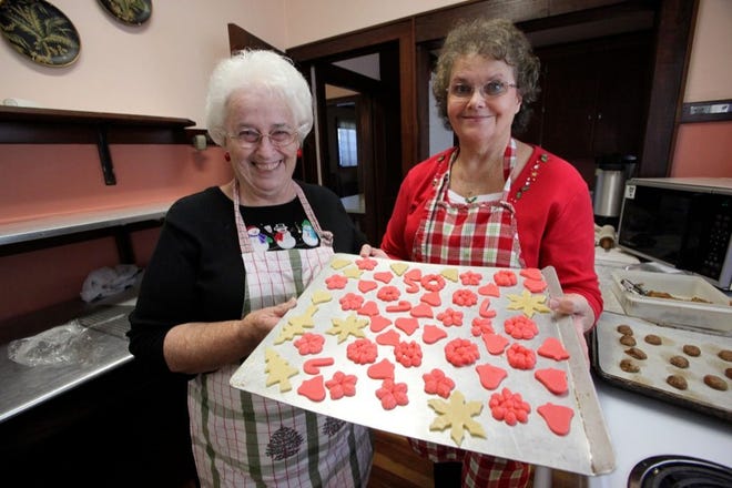 GAIL BUTTS AND PAM WILLINGHAM get a tray of sugar cookies ready to bake Monday at the Lake Hamilton Women's Club. The ladies get to bake all their holiday favorites for a Women's Club event planned for Saturday.