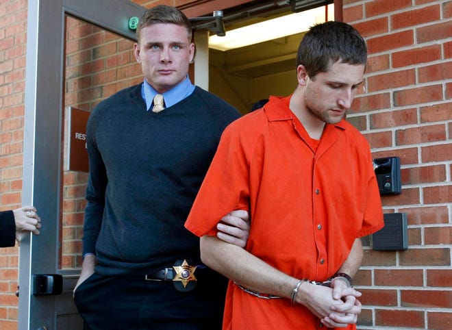 In this Nov. 13, 2012, file photo, Micah Moore, 23, right, is escorted into the Jackson County Courthouse Annex in Independence, Mo., for his murder charge in the death of 27-year-old Bethany Ann Deaton. Moore's lawyer, Melanie Morgan, recanted her client's confession on Wednesday, saying it was "bizarre, nonsensical and most importantly, untrue."