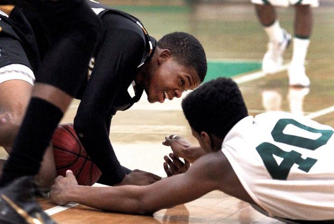 John Clark / Halifax Media

 Shelby's Cedric Cannon, left, and Ashbrook's Russell Bess dive for a loose ball during their game Wednesday night at the Green Wave's Rhodes Gymnasium.