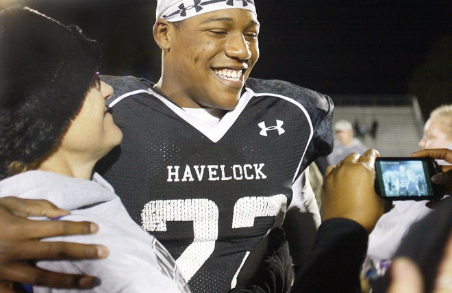 Havelock’s Pharoh Cooper is all smiles as he embraces fans and poses for pictures Friday night. The senior quarterback has helped lead the Rams to the state 3A championship game.