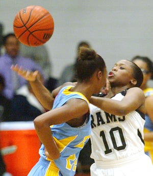 Havelock’s Apriel Barrette, right, battles East Carteret’s LaShaunda Rogers for the ball on Tuesday at Havelock High. The Rams won the game 57-38.