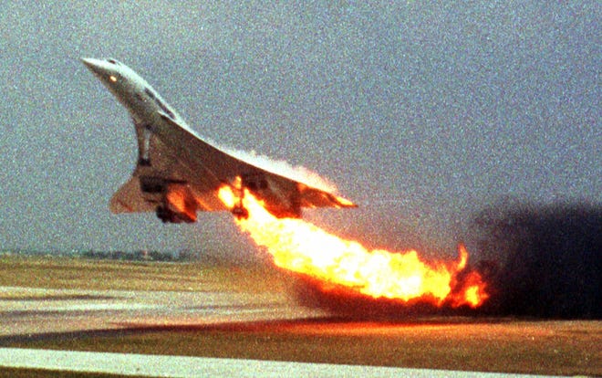 FILE - In this July 25, 2000, file photo, Air France Concorde flight 4590 takes off with fire trailing from its engine on the left wing from Charles de Gaulle airport in Paris. A French appeals court decided on Thursday, Nov. 29, 2012, to overturn a manslaughter conviction against Continental Airlines for the crash over a decade ago of an Air France Concorde that killed 113 people. Continental Airlines, Inc. and one of its mechanics were convicted in 2010. (AP Photo/Toshihiko Sato, File)