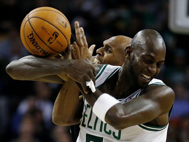 Boston Celtics' Kevin Garnett, right, and Brooklyn Nets' Jerry Stackhouse battle for a loose ball in the second quarter of an NBA basketball game in Boston Wednesday, Nov. 28, 2012