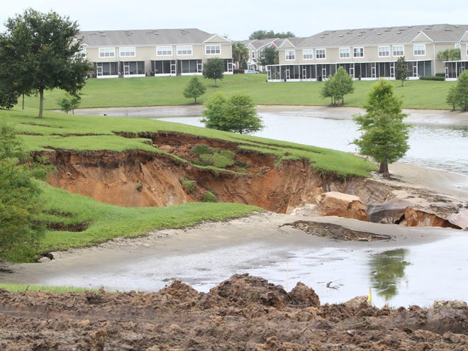 A large sinkhole is shown between apartments at the Fore Ranch subdivision in Ocala on Monday, June 25, 2012. The sinkhole opened up during heavy rain from Tropical Storm Debby.