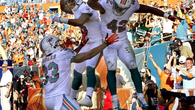 112512 (Bill Ingram/Palm Beach Post):Miami Gardens: Miami Dolphins fullback Charles Clay (42), celebrates with teammates after scoring a touchdown that tide the game at 21 against the Seahawks at Sun Life stadium Sunday in Miami Gardens.