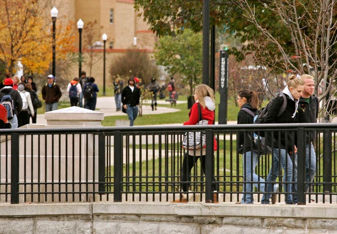 Students walk between classes Thursday, Oct. 28, 2010, on the campus of Northern Illinois University in DeKalb.