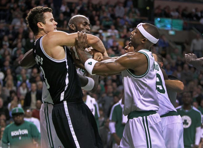 Boston Celtics' Kevin Garnett, center, Jason Terry, front right and Rajon Rondo (partially obscured, back right, confront Brooklyn Nets' Kris Humphries, front left, during a game in Boston on Wednesday, Nov. 28.