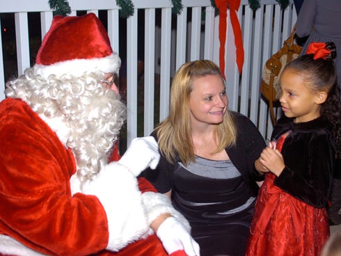 Five-year-old Anna Hart and her mother Kristy got a chance to talk with Santa Claus before all the dancing and singing started at the community tree lighting festivities at the Destin Community Center Thursday evening.