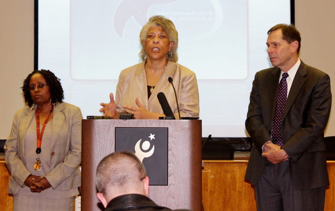 Angela Monson, chairwoman of the Oklahoma City School Board, speaks Thursday during a news conference about the grade scandal at Douglass Mid-High School. Douglass interim Principal Barbara Davis, left, and Oklahoma City Superintendent Karl Springer stand beside her. Photo by Carrie Coppernoll, The Oklahoman