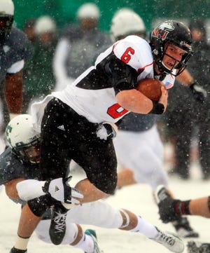 Northern Illinois Huskies quarterback Jordan Lynch (6) is stopped on a run by Eastern Michigan during the second quarter of an NCAA college football game in Ypsilanti, Mich., Friday, Nov. 23, 2012.
