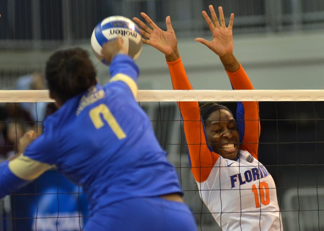 Florida Gators middle blocker Chloe Mann goes for a block against Tulsa outside hitter Tyler Henderson during the first round of the NCAA tournament on Friday at the O'Connell Center in Gainesville.