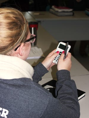 An Arlington High School student uses a remote response device to offer instant feedback in English class. The system was funded by a grant from the Arlington Education Foundation.