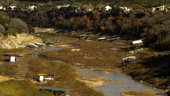 Boat docks are left dry on the banks of Pedernales River in this view from Highway 71 near Spicewood on Friday Nov. 30, 2012.
