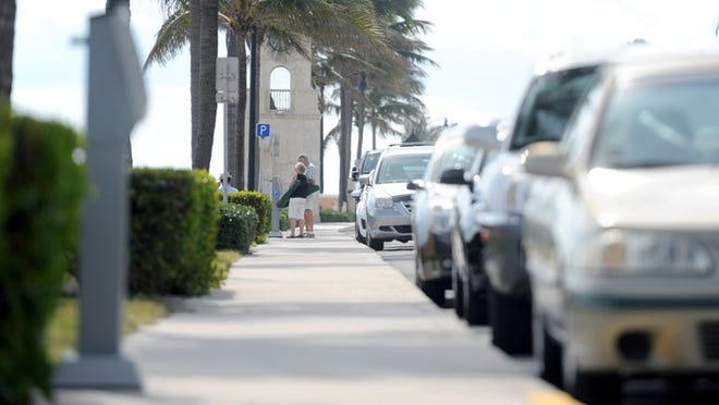 Visitors from Beverly Hills, Fla., pay for an hour of parking Tuesday at Midtown Beach. The town has collected about $512,000 so far this year from non-meter fine revenue.