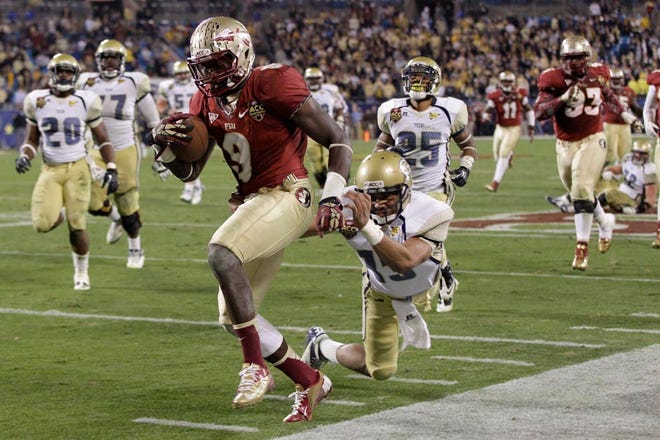 Florida State's Karlos Williams (9) returns an interception as Georgia Tech quarterback Tevin Washington (13) chases in vain during the second half of the ACC Championship college football game in Charlotte on Saturday, Dec. 1, 2012. Florida State won 21-15.