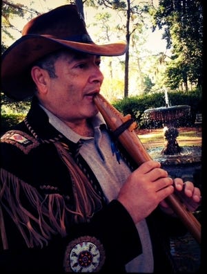 Mike-El plays one of the wooden, hand-carved flutes he says help connect him to his spirituality. 
Photo courtesy of Wilmington Faith & Values