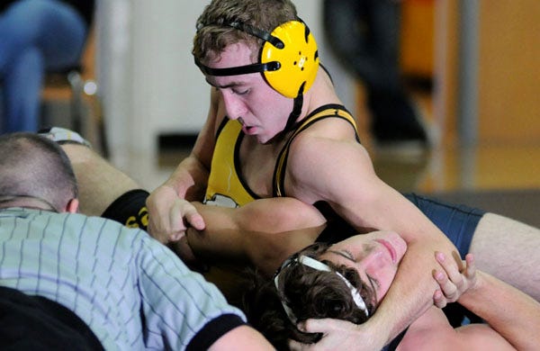 Topsail's Tate Correll (yellow), wrestles South Brunswick's Trey Borsuk (blue) in the 152 pound weight class during the Terry Bache Duals involving 12 schools at Topsail High School in Hampstead Saturday, December 1, 2012.