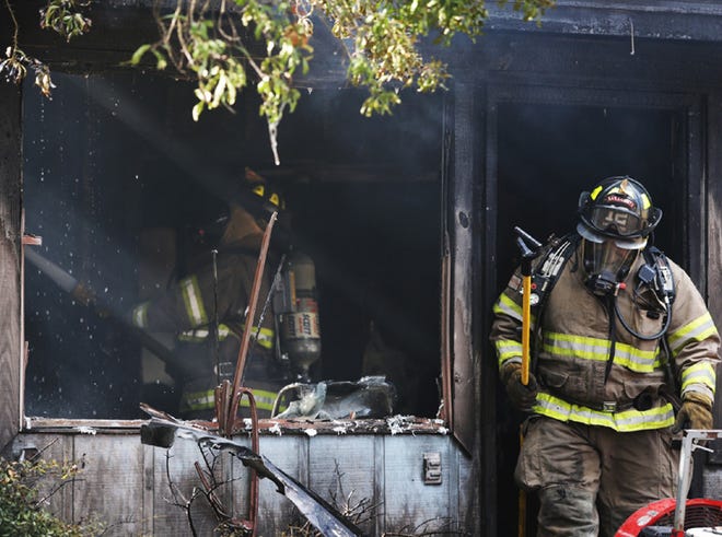 Firefighters battle a blaze at 1834 N. East Ave. on Saturday.