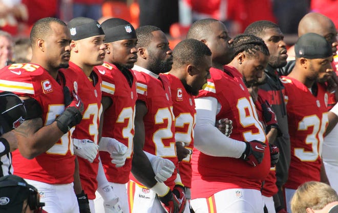 Kansas City Chiefs players stand arm-in-arm during a moment of silence for Jovan Belcher before beating the Carolina Panthers on Sunday in Kansas City.