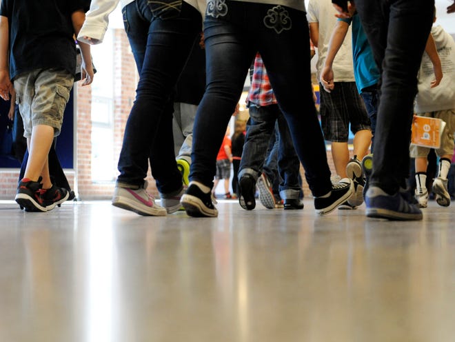 FILE - In this Sept. 11, 2012, photo, students walk in the hallways as they enter the lunch line of the cafeteria at Draper Middle School in Rotterdam, N.Y. School for thousands of public school students is about to get quite a bit longer. Five states announced Monday, Dec. 3, 2012, they will add at least 300 hours of learning time to the calendar in some schools starting in 2013. (AP Photo/Hans Pennink)