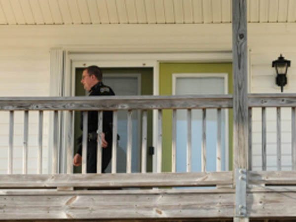Surf City Police Officer Garret Mauck checks to see if a rental home is secure Friday Nov. 29, 2012 in Surf City, N.C. Surf City officers cater to absent property owners with a cottage check service.