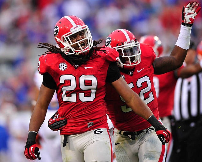 Georgia Bulldogs linebacker Jarvis Jones (29) and Georgia Bulldogs linebacker Amarlo Herrera (52) celebrate after a fumble recovery during the NCAA college football game between the Georgia Bulldogs and the Florida Gators in Jacksonville, Fla., Sat., Oct. 27, 2012. (AJ Reynolds/Staff)