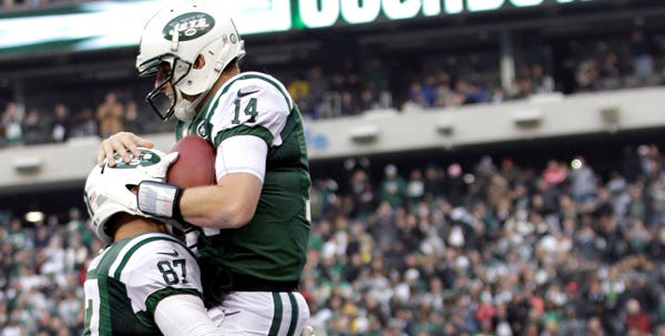 Jets quarterback Greg McElroy (14) celebrates with teammate Konrad Reuland after McElroy's 1-yard touchdown pass to Jeff Cumberland during the second half of New York's 7-6 victory over Arizona on Sunday. McElroy replaced Mark Sachez, who was benched after throwing three interceptions.