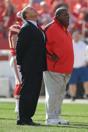 Kansas City Chiefs general manager Scott Pioli, left, and coach Romeo Crennel stand together before an NFL football game against the Carolina Panthers at Arrowhead Stadium on Sunday.