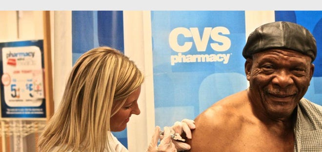 Pro Football Hall of Famer Carl Eller receives flu shot at a CVS/pharmacy in Minneapolis as part of National Influenza Vaccination Week. (PRNewsFoto/CVS/pharmacy)