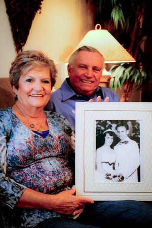 Bill and Bridget Kopack hold a photograph of their high school prom date from 1957 in their Ocala, Fla., home on Wednesday November 28, 2012.