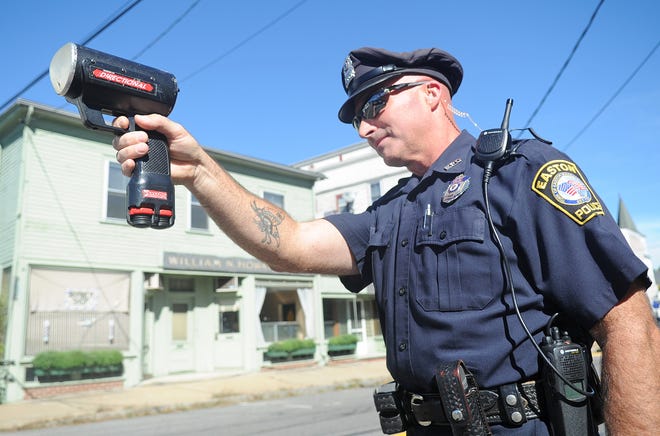 Easton police officer Patrick Healey uses a radar gun to enforce traffic laws on Main Street in Easton recently.