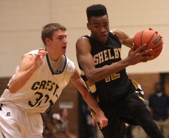 Shelby's Chris Wray, right, tries to get past Charger defender Andrew Bowen in Tuesday's non-conference basketball contest at Ed Peeler Gymnasium. The visiting Golden Lions eeked out a 70-69 victory.