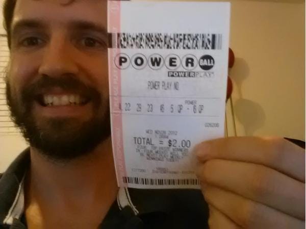 Nolan Daniels, an Arizona software engineer, purports to be holding one of two winning tickets from Wednesday's record Powerball jackpot. The photo is a hoax. (Photo provided)
