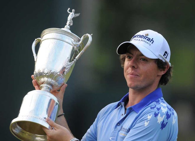 Rory McIlroy holds up the U.S. Open championship trophy, after winning the U.S. Open with a score of 16-under par at Congressional Country Club in Bethesda, Maryland, Sunday June 19, 2011. (Doug Kapustin/MCT)