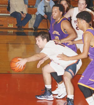 Pontiac’s Logan Gschwendtner tries to keep the ball in play as Rantoul’s Johnny Jones and Talon Hardin look on. PTHS topped the Eagles 59-43.