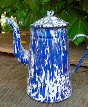 This blue and white coffeepot is correctly called enamelware or graniteware. The formula for coating the metal actually contains a small amount of granite powder.