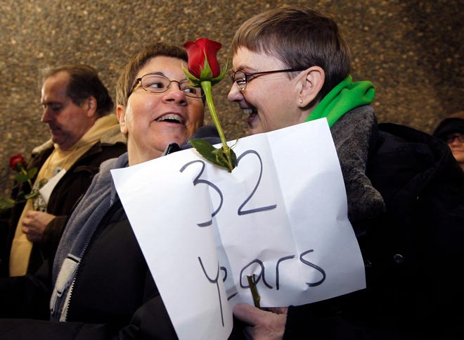 Melody Platt, left, and her partner Beratta Gomillion wait among the first couples in line to be issued a marriage license to a same-sex couple, Wednesday, Dec. 5, 2012, in Seattle. King County Executive Dow Constantine was to began issuing the licenses just after midnight, Thursday, Dec. 6, immediately upon certification of the November election that passed Referendum 74 allowing same-sex couples to wed. The couple are planning on getting married on their 32nd anniversary, Monday Dec. 12. (AP Photo/Elaine Thompson)