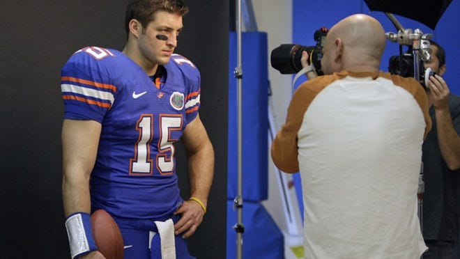 In this March 19, 2010 photo,Tim Tebow poses for photographer Tim Mantoani during a photography shoot in Orlando.