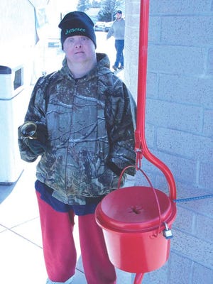 Abilities Plus client Eddie DePauw rings the bell at the Salvation Army kettle at Walgreens in Kewanee. The local Salvation Army has an arrangement with Abilities Plus to provide bell ringers at the store.