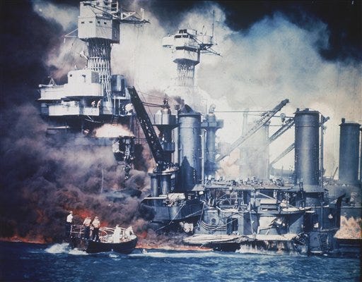 FILE - In this U.S. Navy file photo, a small boat rescues a USS West Virginia crew member from the water after the Japanese bombing of Pearl Harbor, Hawaii on Dec. 7, 1941 during World War II. Two men can be seen on the superstructure, upper center. The mast of the USS Tennessee is beyond the burning West Virginia. On Dec. 7, 1941, Japanese Imperial Navy navigator Takeshi Maeda guided his Kate bomber to Pearl Harbor and fired a torpedo that helped sink the USS West Virginia. President Barack Obama on Thursday Dec. 6, 2012 issued a proclamation declaring Dec. 7 a day of remembrance in honor of the 2,400 Americans who died at Pearl Harbor. He urged federal agencies, organizations and others to fly their flags at half-staff.
