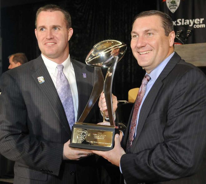 Will.Dickey@Jacksonville.com Northwestern coach Pat Fitzgerald (left) and Mississippi State coach Dan Mullen hold the Gator Bowl trophy during a news conference on Thursday in Jacksonville.